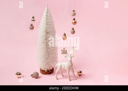 Christmas minimalist composition with white tree, reindeer and hanging baubles Stock Photo