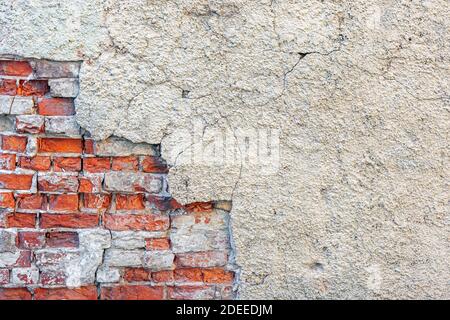 Damaged plaster on a brick wall. For use as abstract backgrounds and textures. Stock Photo