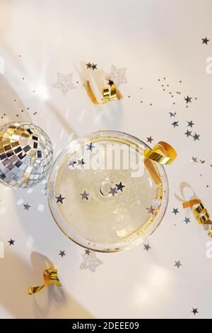 Glass of champagne in a coupe with mini disco ball Stock Photo