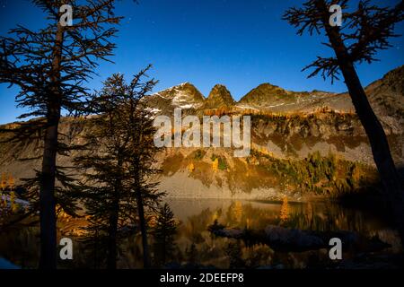 WA18631-00...WASHINGTON - Moonlight on Lower Ice Lake as stars are appearing in the evening sky in the Glacier Peak Wilderness. Stock Photo