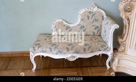Vintage Wooden Classical Carved Sofa Upholstered in a Beautiful Cloth. Retro Style. Furniture for Refined Interior. Old, Palace Furniture. Stock Photo