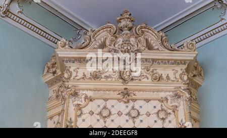 Antique Old Fashioned Tiled Stove. Textures, Backgrounds  Ceramic Tile on the Stove for Heating. Stock Photo