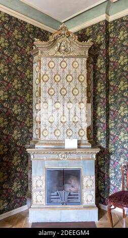 Antique Old Fashioned Tiled Stove. Textures, Backgrounds  Ceramic Tile on the Stove for Heating. Stock Photo