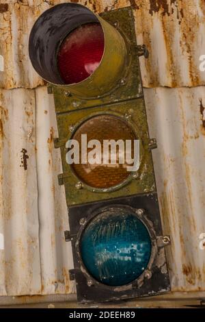 Old traffic light on metal wall Stock Photo
