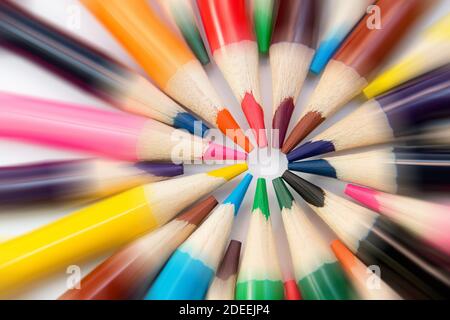 An assortment of colour pencils in circle, spiral on white background. School supplies, creativity concept Stock Photo