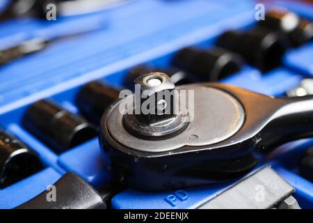 Macro close up of reversibel ratchet wrench head on socket set box Stock Photo