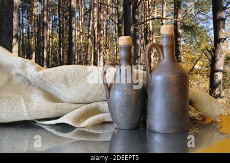 Old clay bottles for storing oil, wine Stock Photo