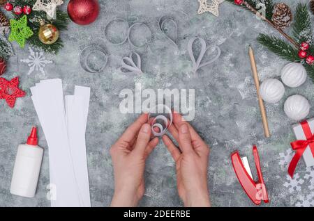 Christmas diy craft, making three-dimensional paper decor for decorating a room. Step-by-step photo instructions. Step 33- we get the sixth decorative Stock Photo