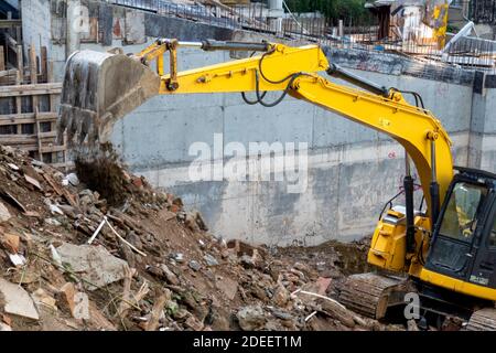 Urban transformation.Heavy equipment being used to tear tearing down building construction Stock Photo