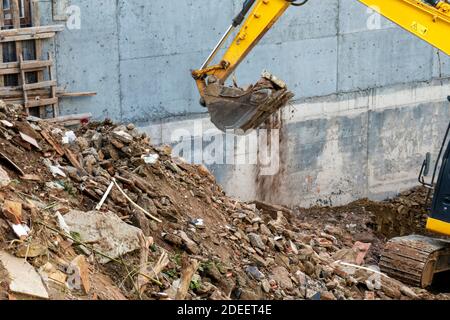 Urban transformation.Heavy equipment being used to tear tearing down building construction Stock Photo