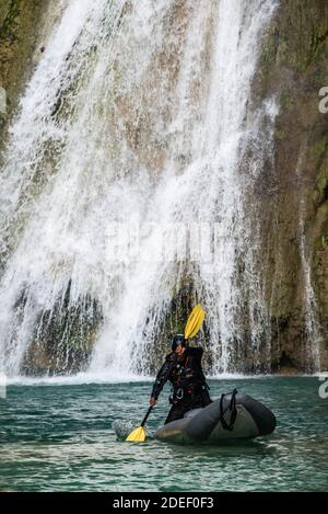 Kayaker at the base of Minas Viejas waterfall, Huasteca Potosina, San Luis Potosi, Mexico