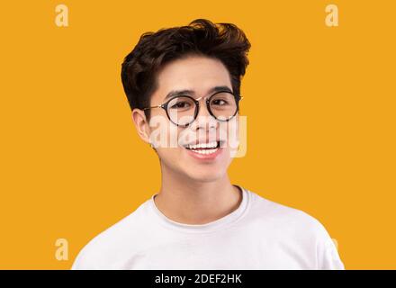 Portrait Of Smiling Young Asian Man Wearing Eyeglasses Stock Photo