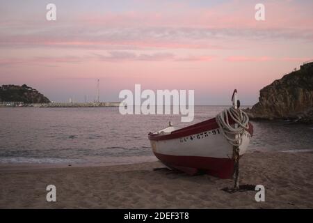 Sunset in Blanes Costa Brava with a typical boat from the area Stock Photo