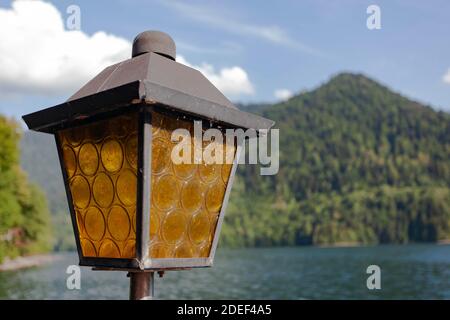 Street old vintage lantern against the green mountains Stock Photo