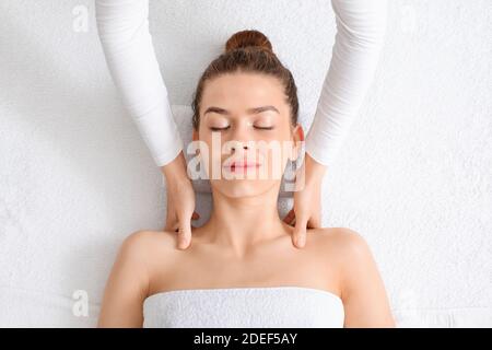 Top view of peaceful young lady having healing body massage Stock Photo