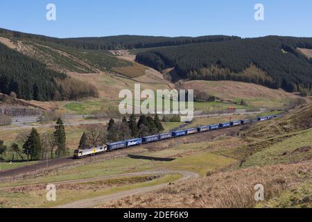 DB Cargo Class 92 locomotive at  Harthorpe on the west coast main line in Scotland with the Eddie Stobart / Tesco intermodal container freight train Stock Photo