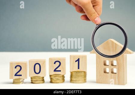 2021 wooden blocks and miniature house. Real estate concept. Family budget planning. Investments, plans, savings. Mortgage and mortgage rates. Forecas Stock Photo