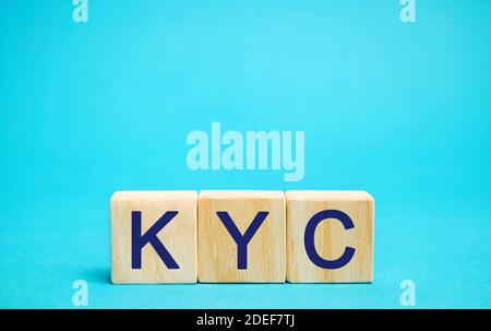 Wooden blocks with the word KYC - Know Your Customer / Client. Verify the identity, suitability and risks involved with maintaining a business relatio Stock Photo