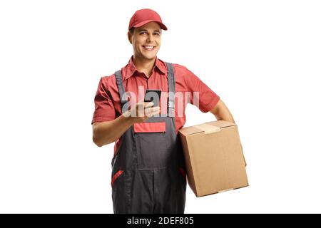 Male courier in a uniform holding a box and using a mobile phone isolated on white background Stock Photo