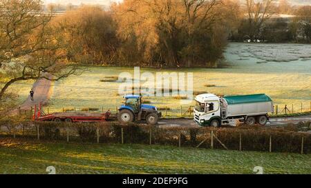 November 2020 - Tractor with trailer and truck outside on a frosty morning in rural Somerset near Cheddar, Stock Photo