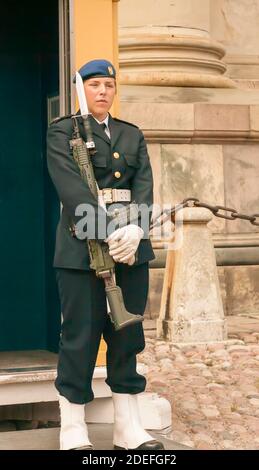 Female soldier stands guard outside the Royal Palace in the Stortorget, Gamla Stan square, Stockholm, Sweden Stock Photo