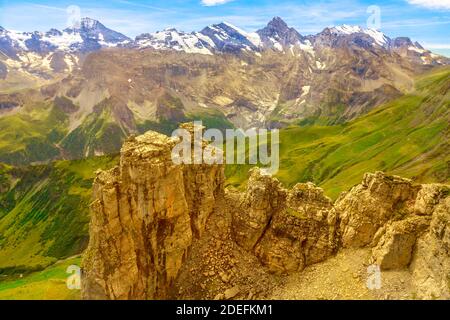 Aerial view above cliffs, rocky mountains and valleys with lakes and rivers at Birg to Schilthorn. Snow-capped peaks of Bernese Prealps, Canton of Stock Photo