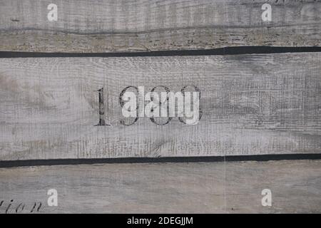 wooden texture of three planks with number 1983 embrassed on it Stock Photo