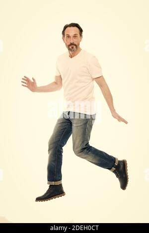 Maintaining active lifestyle. Active man jump isolated on white. Middle age adult. Mature person in casual style. Healthy ageing. Active and energetic. Stay active as you get older. Stock Photo