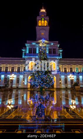 Christmas tree and new year decorations in front of the town hall building, at night, in the city center of Arad, Romania Stock Photo