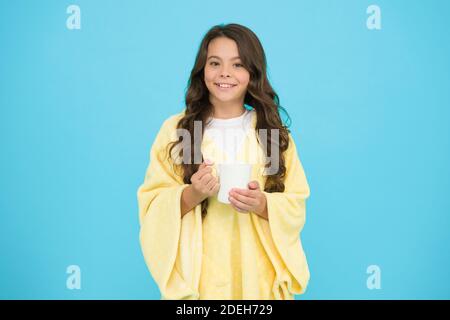 Health Benefits of Drinking Milk Before Bed. Little child hold mug. Girl in pajamas drinking tea. Relaxation before sleep. Drinking milk just before heading to bed. Bedtime Beverages. Evening routine. Stock Photo