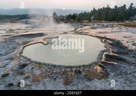 The Doublet Pool is an intermittant clearwater hot spring on Geyser HIll in the Upper Geyser Basin, Yellowstone Nationla Park, Wyoming, USA. Stock Photo