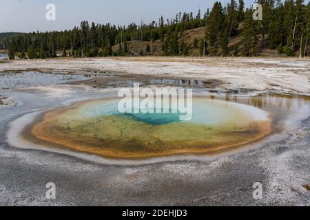 The Chromatic Pool is an intermittent clearwater hot spring in the Upper Geyser Basin of Yellowstone National Park, Wyoming, USA. Stock Photo