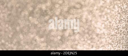 Golden abstract Christmas Background with   sparkling glittering lights. Shiny festive New Year greeting card Stock Photo