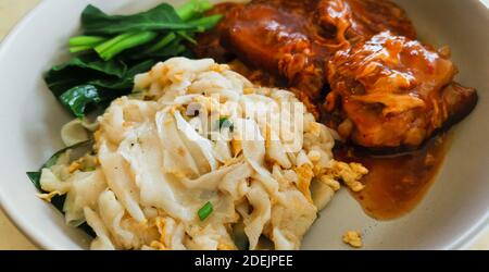 Fried Noodles with Braised Pork Ribs. Selective focus on yummy noodles. Food background. Stock Photo