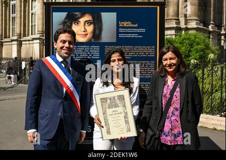 L-R : Paris Mayor Deputy Patrick Klugman, Lina Al Hathloul with honorary citizenship for her sister, jailed Saudi activist Loujain Al Hathloul and Paris Mayor Anne Hidalgo pose next to a portrait of the jailed activist, near Hotel de Ville or City Hall, in Paris, France on June 21, 2019. Photo by Balkis Press/ABACAPRESS.COM Stock Photo