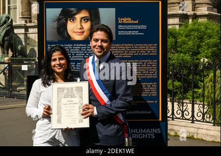 L-R : Lina Al Hathloul with honorary citizenship for her sister, jailed Saudi activist Loujain Al Hathloul and Paris Mayor Deputy Patrick Klugman pose next to a portrait of the jailed activist, near Hotel de Ville or City Hall, in Paris, France on June 21, 2019. Photo by Balkis Press/ABACAPRESS.COM Stock Photo