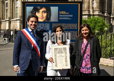 L-R : Paris Mayor Deputy Patrick Klugman, Lina Al Hathloul with honorary citizenship for her sister, jailed Saudi activist Loujain Al Hathloul and Paris Mayor Anne Hidalgo pose next to a portrait of the jailed activist, near Hotel de Ville or City Hall, in Paris, France on June 21, 2019. Photo by Balkis Press/ABACAPRESS.COM Stock Photo