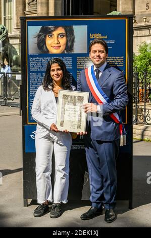 L-R : Lina Al Hathloul with honorary citizenship for her sister, jailed Saudi activist Loujain Al Hathloul and Paris Mayor Deputy Patrick Klugman pose next to a portrait of the jailed activist, near Hotel de Ville or City Hall, in Paris, France on June 21, 2019. Photo by Balkis Press/ABACAPRESS.COM Stock Photo