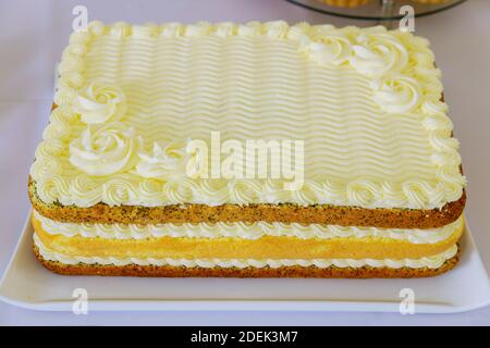 Festive layer cake decorated with white icing. Close up. Stock Photo