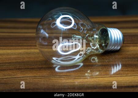 light bulb and reflection on the table Stock Photo