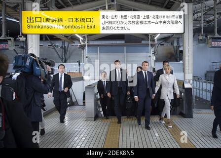 France S President Emmanuel Macron Front L And His Wife Brigitte Macron Arrive At A Train Station In Tokyo On June 27 19 To Board Their Shinkansen Bullet Train To Kyoto Photo By