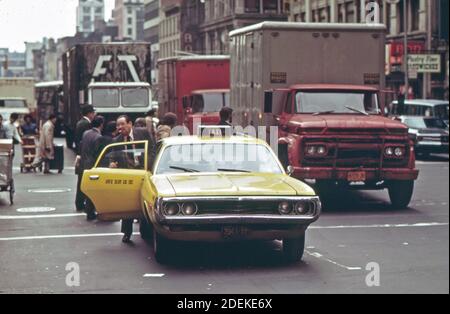 1970s Photo (1973) -  Taking on a fare; cab blocks traffic in Midtown Manhattan (New York City) Stock Photo