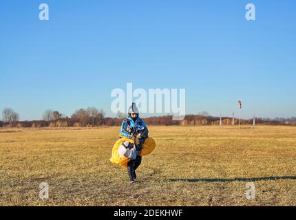 skydivers in the field after landing Stock Photo