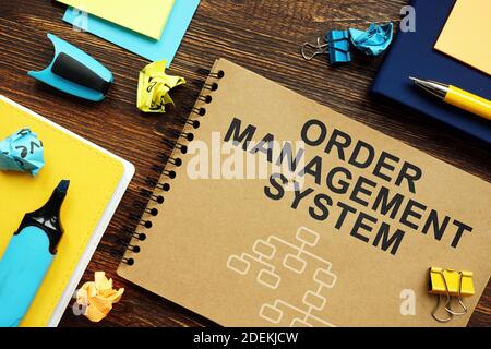 Order Management System OMS papers with charts on the desk. Stock Photo