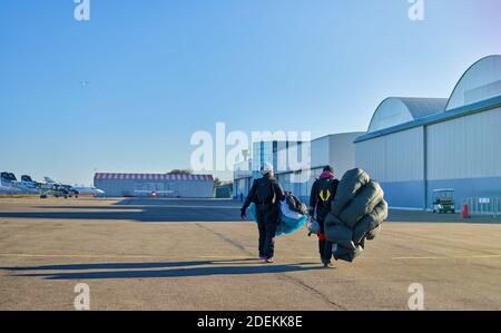 skydivers in the field after landing Stock Photo