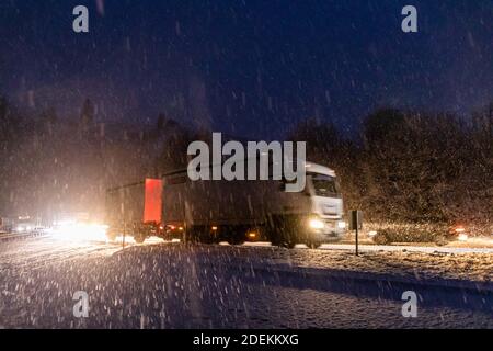 Breitnau, Germany. 01st Dec, 2020. Vehicles drive in winter weather with snowfall on the B31 through the Black Forest. It had begun to snow during the night down to lower altitudes, the snow ploughs are in operation. Credit: Philipp von Ditfurth/dpa/Alamy Live News Stock Photo