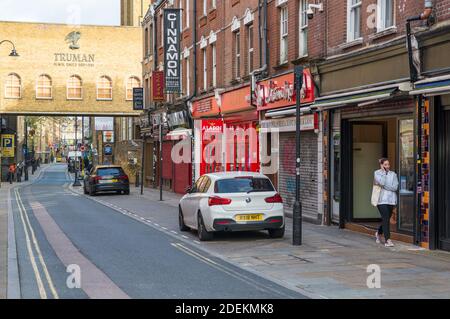 View along Brick Lane towards the Truman Black Eagle brewery and Indian restaurants and curry houses, Spitalfields, London, England, UK Stock Photo