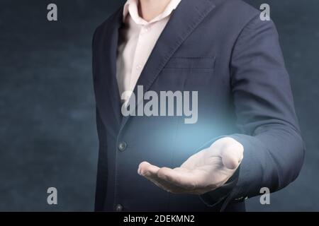 Businessman with empty hand. An empty workpiece. blue glow in the empty open hand of a businessman. copy space Stock Photo