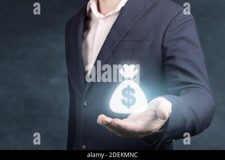 Business people holding dollar sign Stock Photo - Alamy