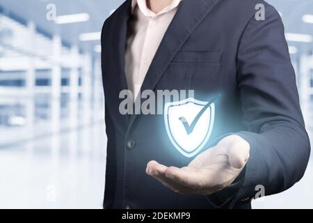 business information security concept. businessman holds security symbol in hand. concept of cyber security, data protection, protection against hacke Stock Photo